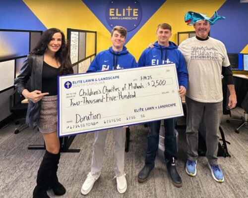 Elite team presenting donation check at an event