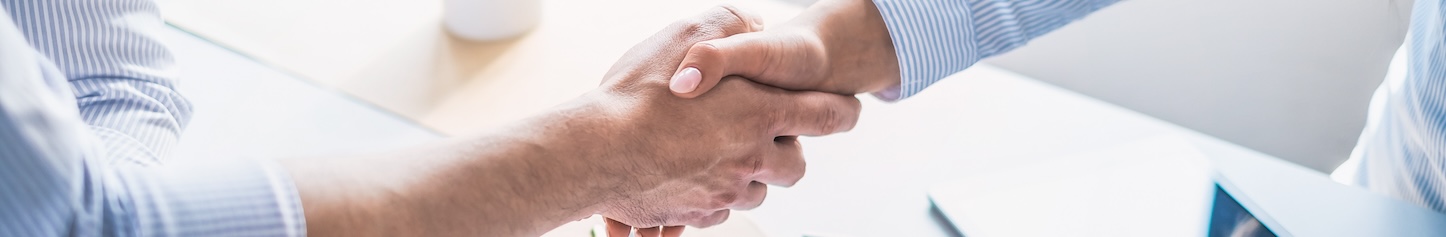 Close-up of a handshake symbolizing service agreement