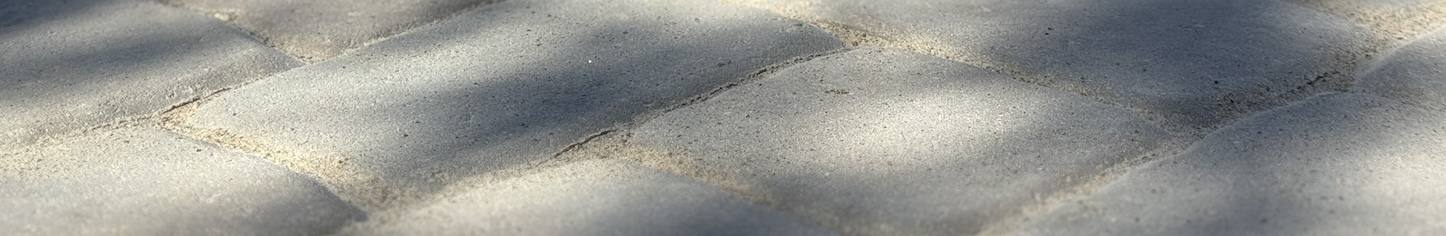 Sunlight casting shadows on stone walkway