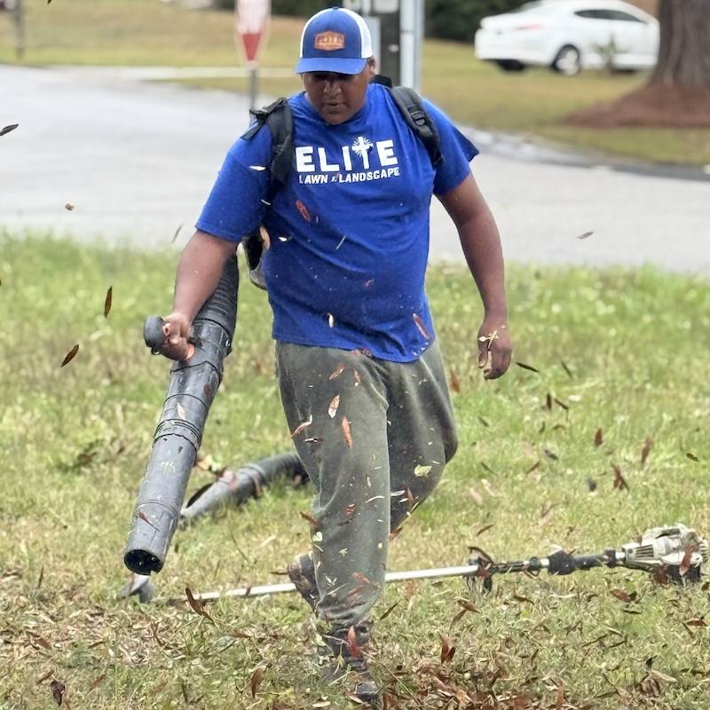 Team member handling landscape pipe