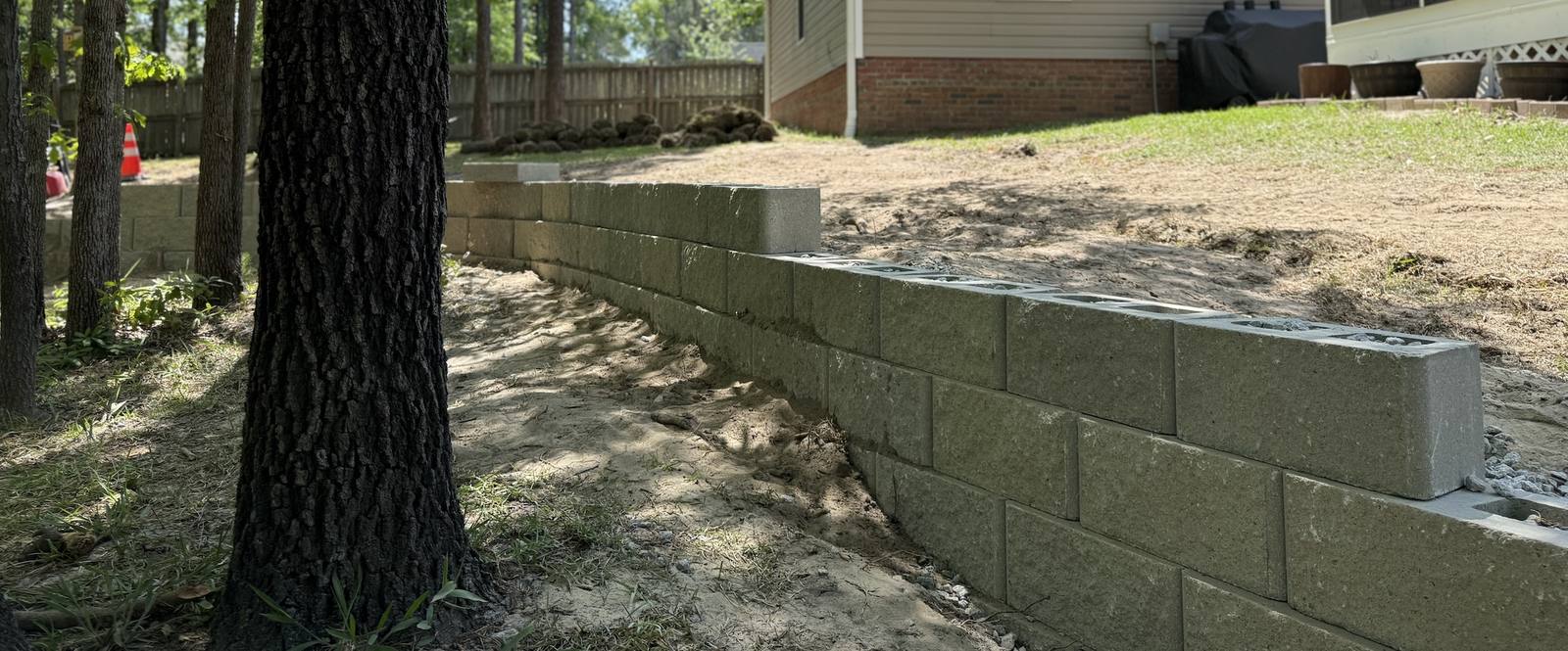Retaining wall construction in progress with level base