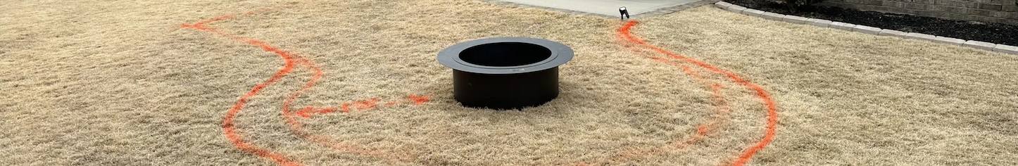 Black irrigation tubing beside a trench