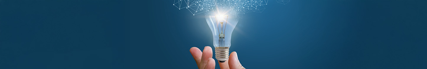 Hand holding a light bulb symbolizing bright ideas